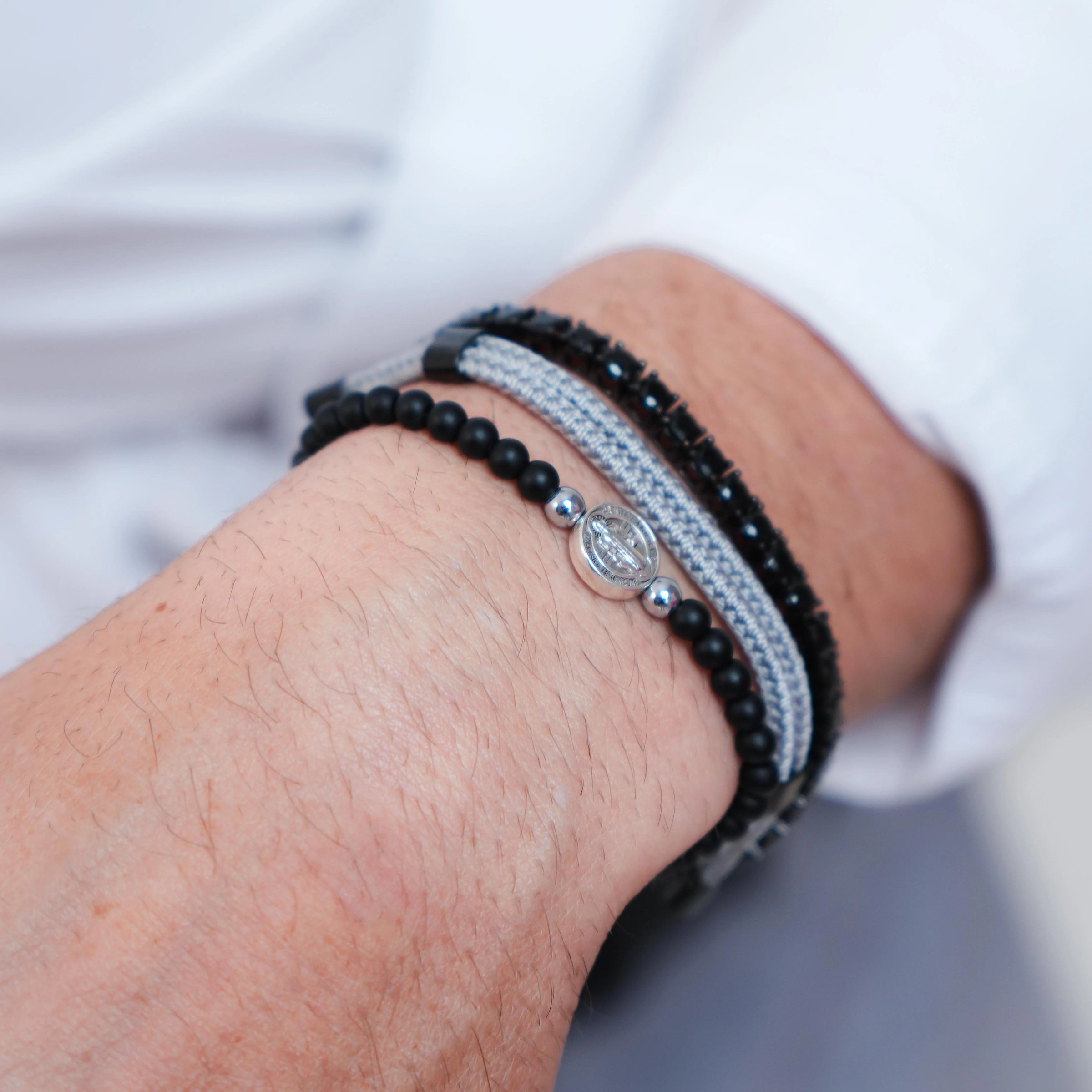 Pulseira Porto cinza no pulso combinada com pulseiras pretas