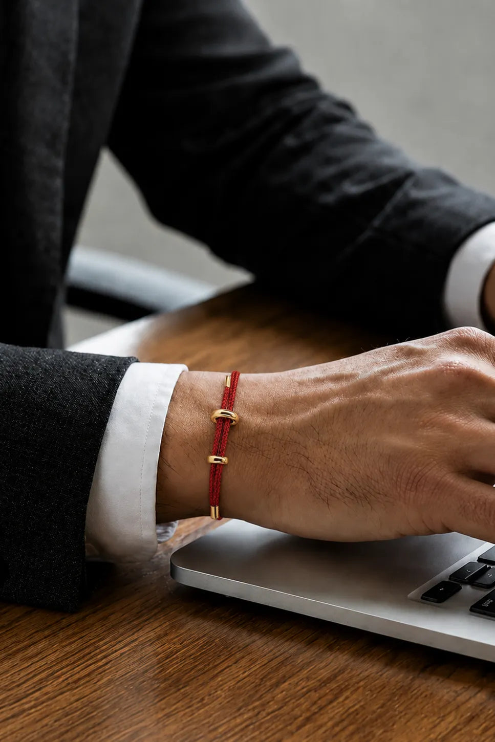 Pulseira masculina de corda vermelha usada com terno no trabalho
